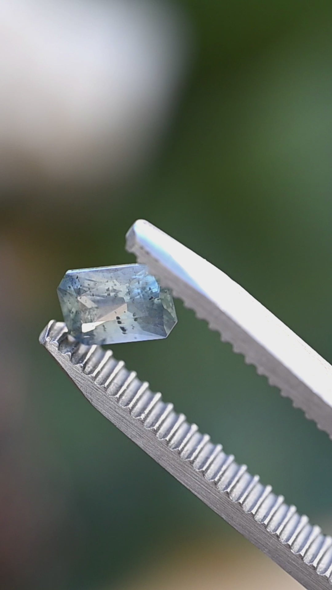 Watch this untreated 0.71 carat Montana sapphire reveal its smoky aqua blue color, precision radiant faceting, and naturally occurring crystal inclusions in motion.