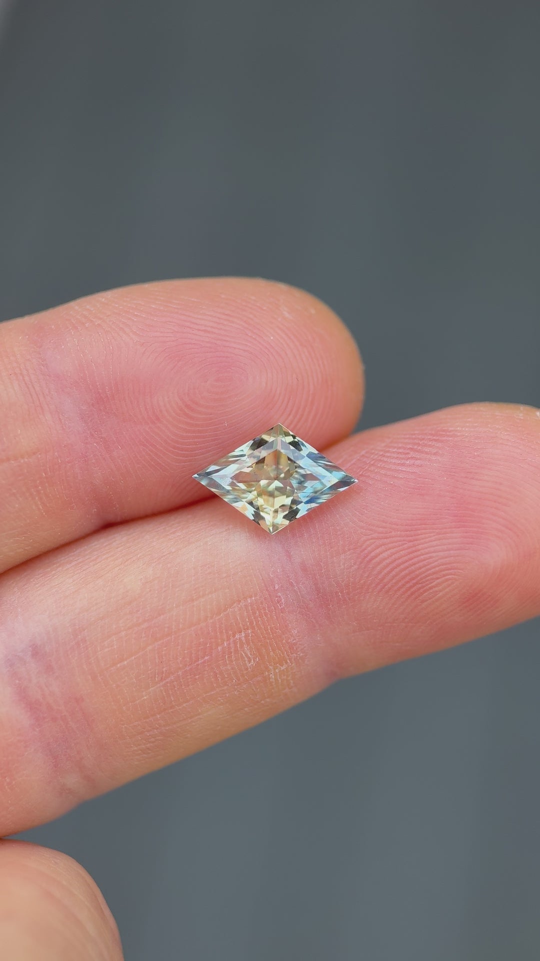 Handheld video of a Madagascar parti sapphire, 3.07 carats, showing detailed brilliance and precise faceting in lozenge cut