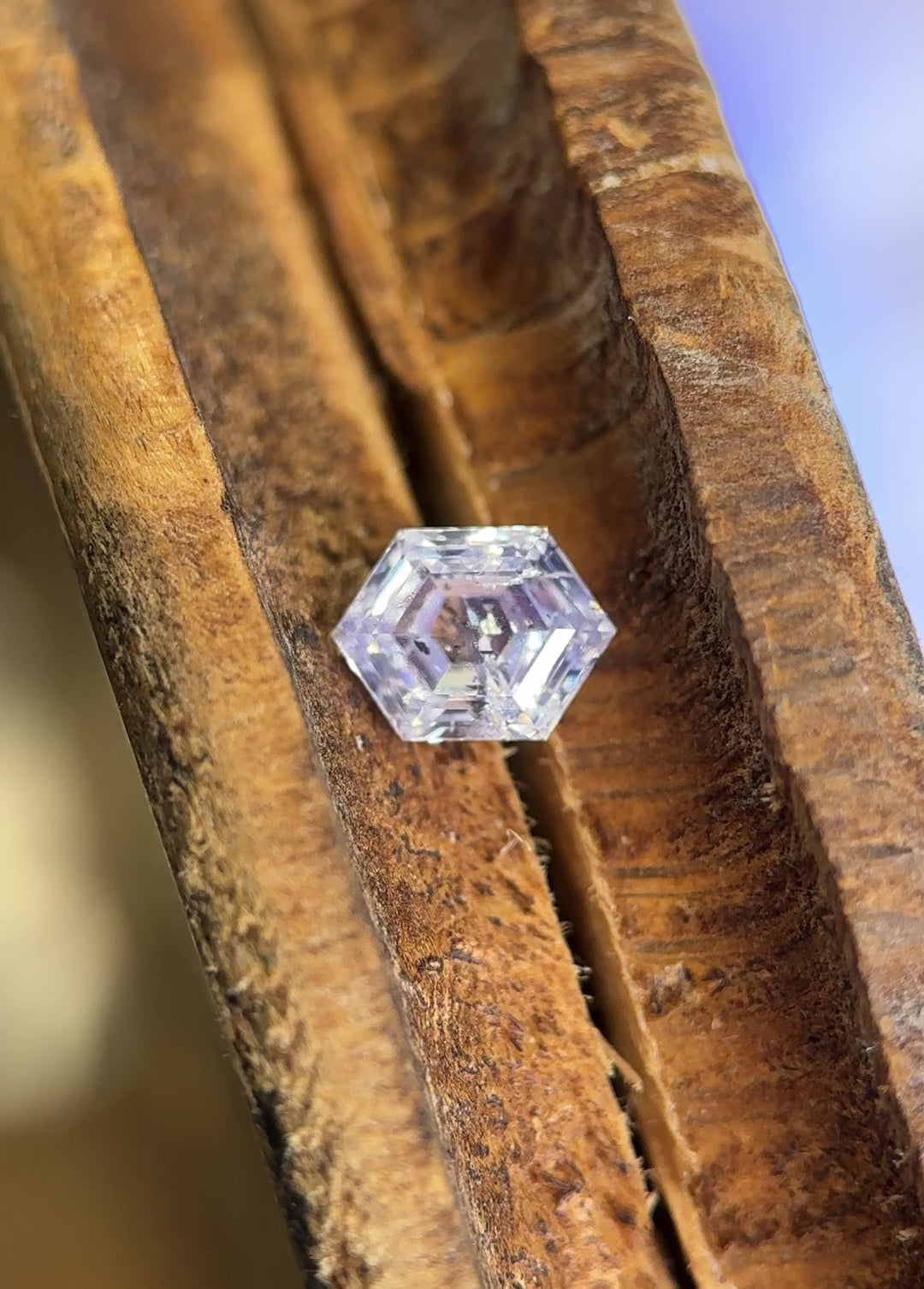 UV fluorescence video of a 1.01 carat G color I2 clarity hexagonal step cut diamond from Gahcho Kué, Canada, glowing vivid blue under ultraviolet light, demonstrating the stone’s natural fluorescence and authenticity.