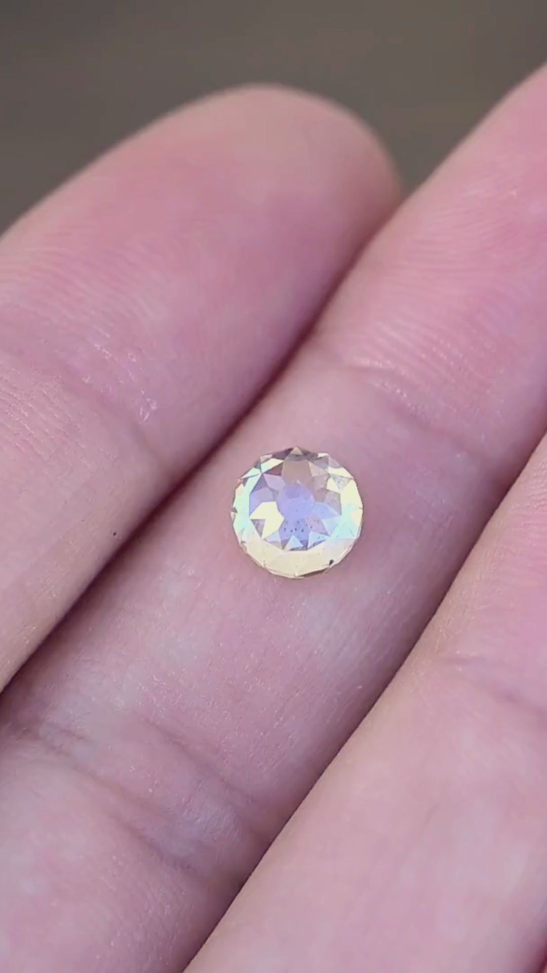 1.92 carat round Mughal cut South African diamond shown in motion on a hand, revealing its scale, natural inclusions and changing champagne, ivory and silvery reflections.