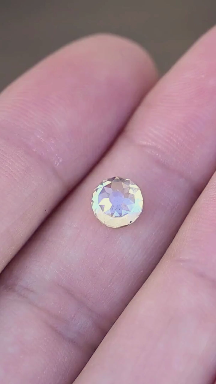 1.92 carat round Mughal cut South African diamond shown in motion on a hand, revealing its scale, natural inclusions and changing champagne, ivory and silvery reflections.