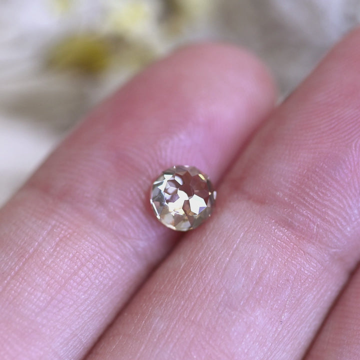 Rotating loose 1.15 carat champagne fancy light brown Mughal cut diamond from South Africa, showing the faceted dome and warm sparkle in light.
