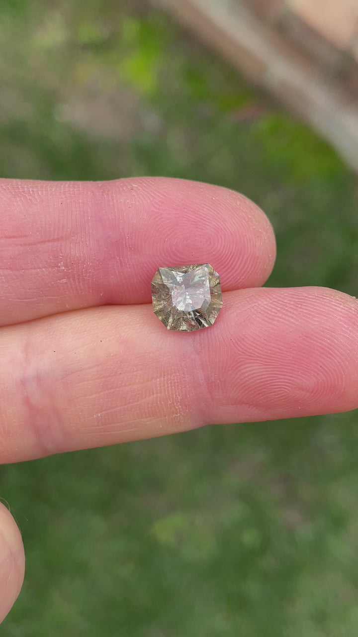 Natural lighting video of a 3.82 carat unheated Umba River sapphire transitioning between grey, pink, and peach hues.