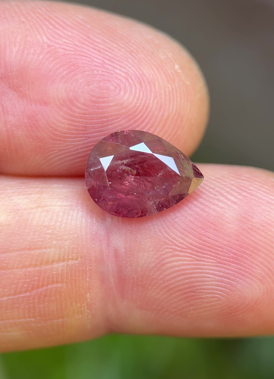 Natural light video of a 3.75 carat pear-shaped sapphire showing orange-red color shift and internal inclusions typical of Umba River origin