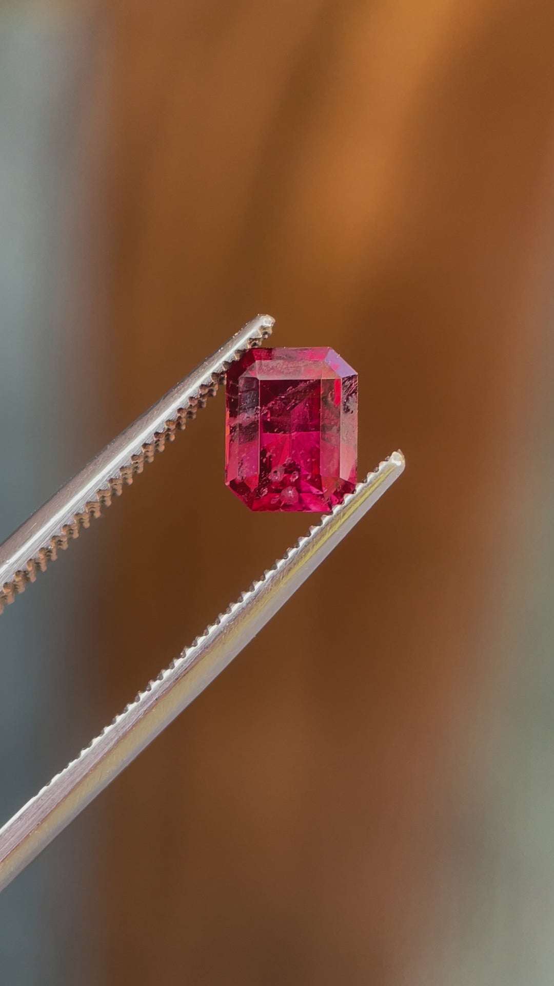 360-degree video showcasing a 1.36 carat red-pink garnet gemstone from Kenya, highlighting its modified octagonal step cut, vibrant color, and natural untreated brilliance.