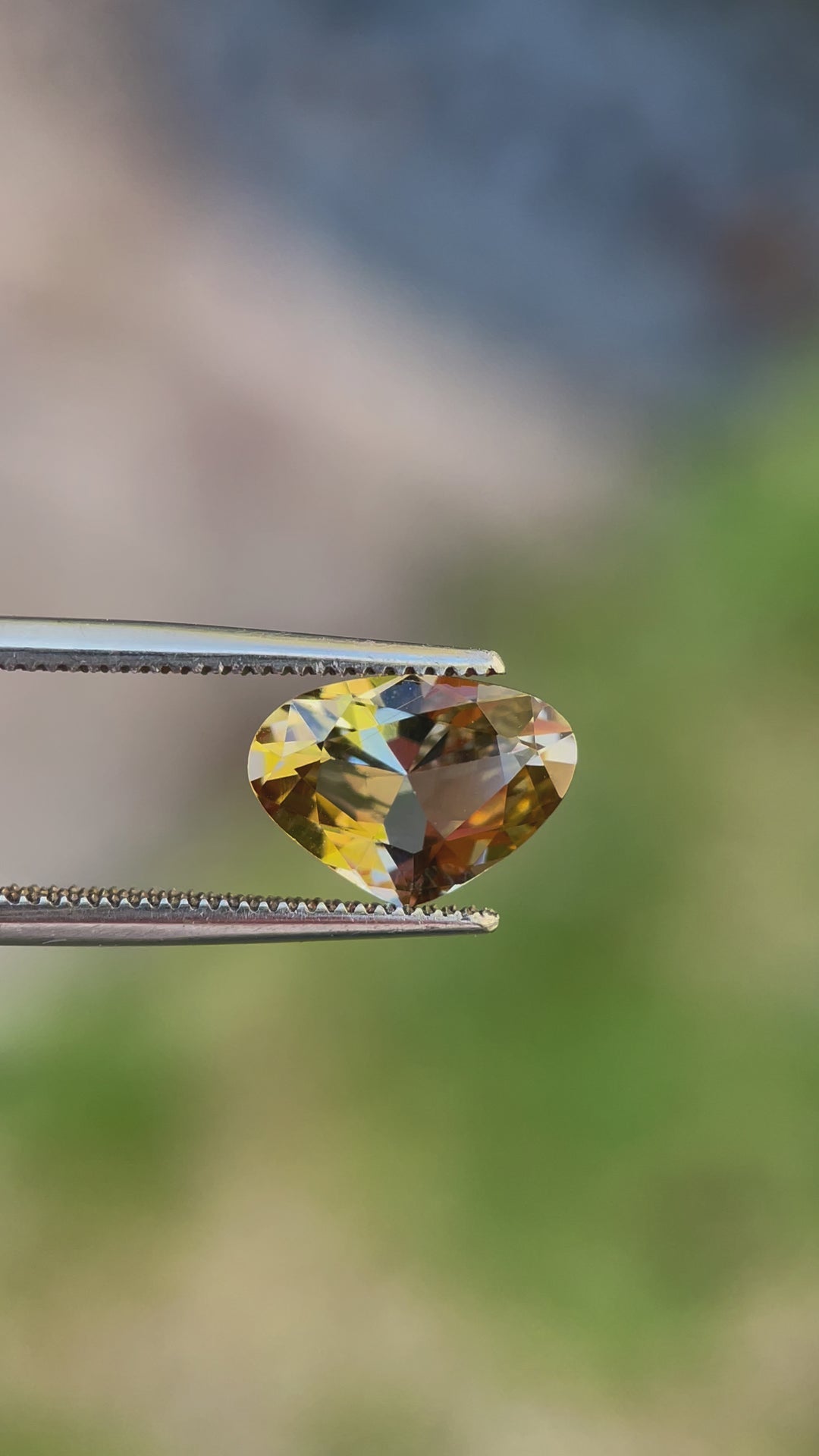 Close-Up Video of a Wide Pear Brilliant Cut Tanzanite Gemstone with Teal, Gold, and Yellow Colors, Weighing 2.48 Carats, and Dimensions 8.07 x 11.16 x 4.79 mm, from Merelani Hills, Arusha Region, Tanzania - No Treatment