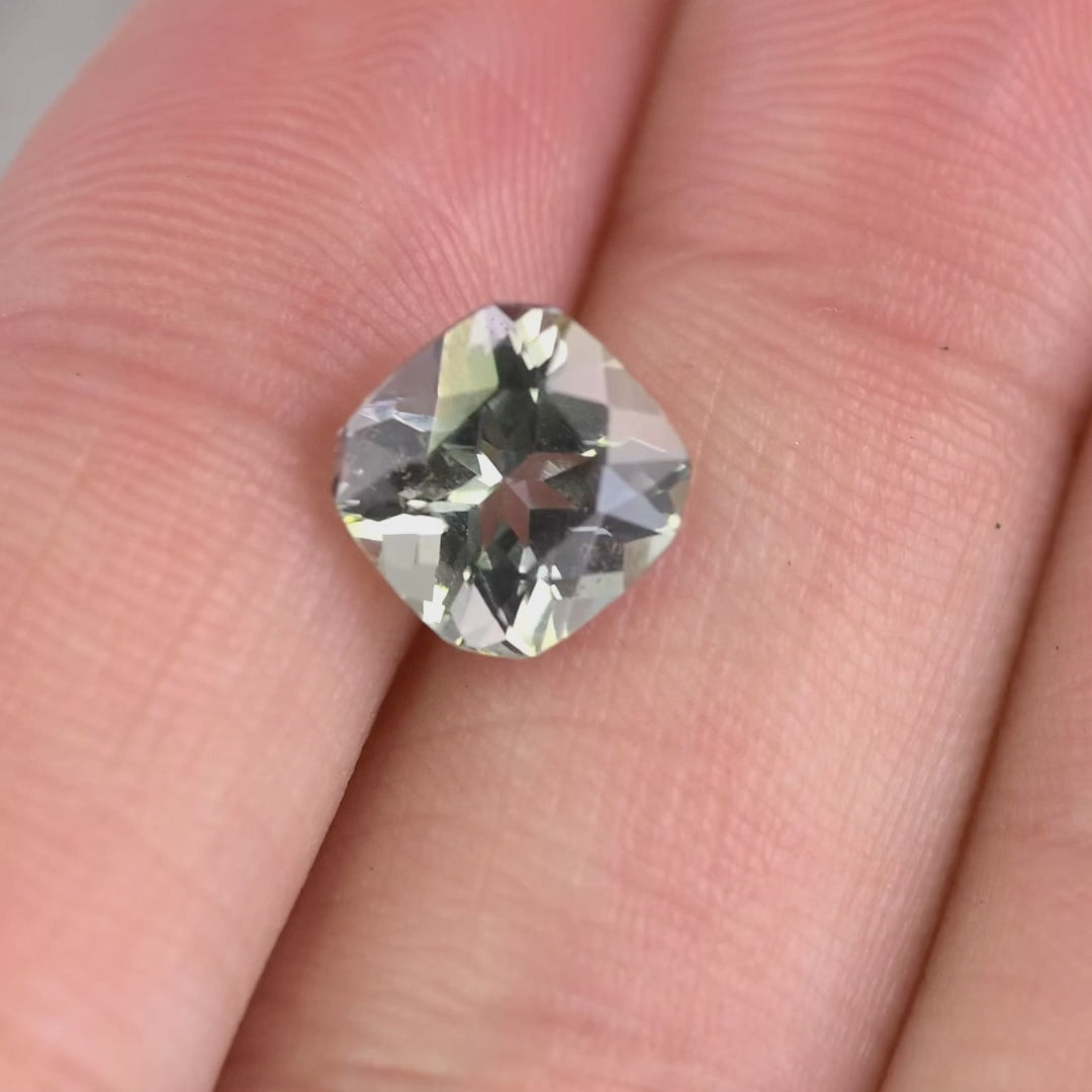 2.74 carat purple teal green Tanzanite square radiant gemstone rotating under natural light, custom geometric faceted Tanzanite from Merelani Hills Tanzania showing color shift and brilliance for custom jewelry design