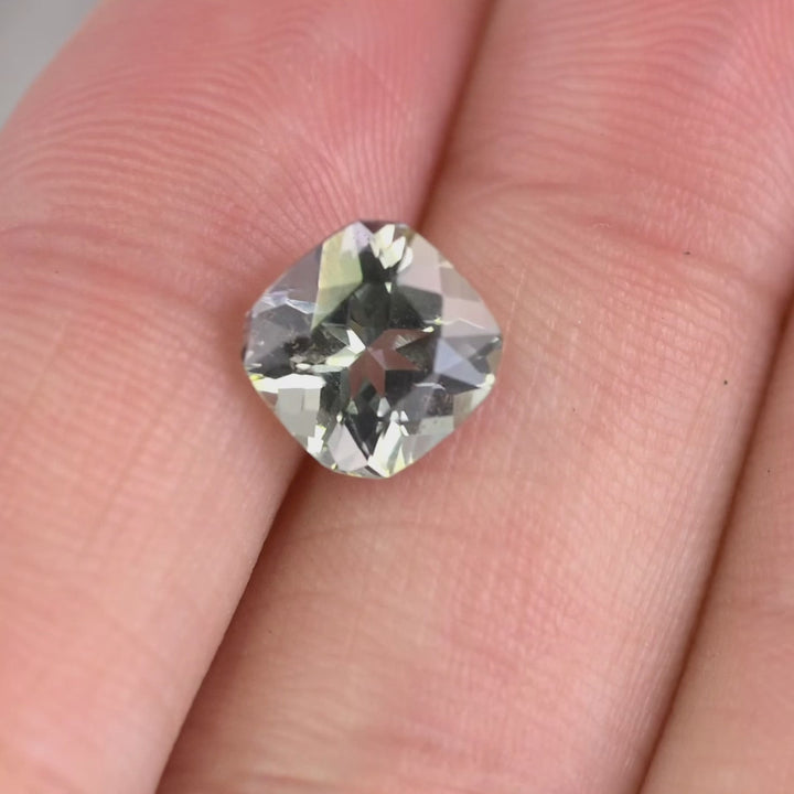 2.74 carat purple teal green Tanzanite square radiant gemstone rotating under natural light, custom geometric faceted Tanzanite from Merelani Hills Tanzania showing color shift and brilliance for custom jewelry design