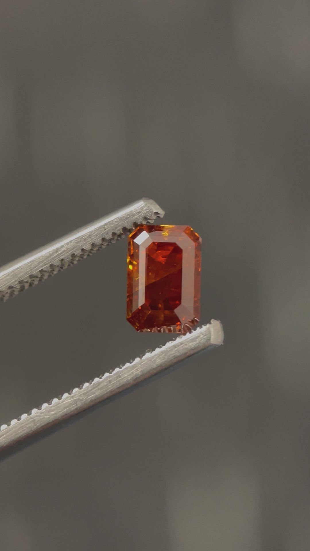 This 1.02CT cognac diamond features a striking deep brown-orange color and a mesmerizing emerald step-cut design. See the intricate facets shine as the light reflects off this exceptional gem.