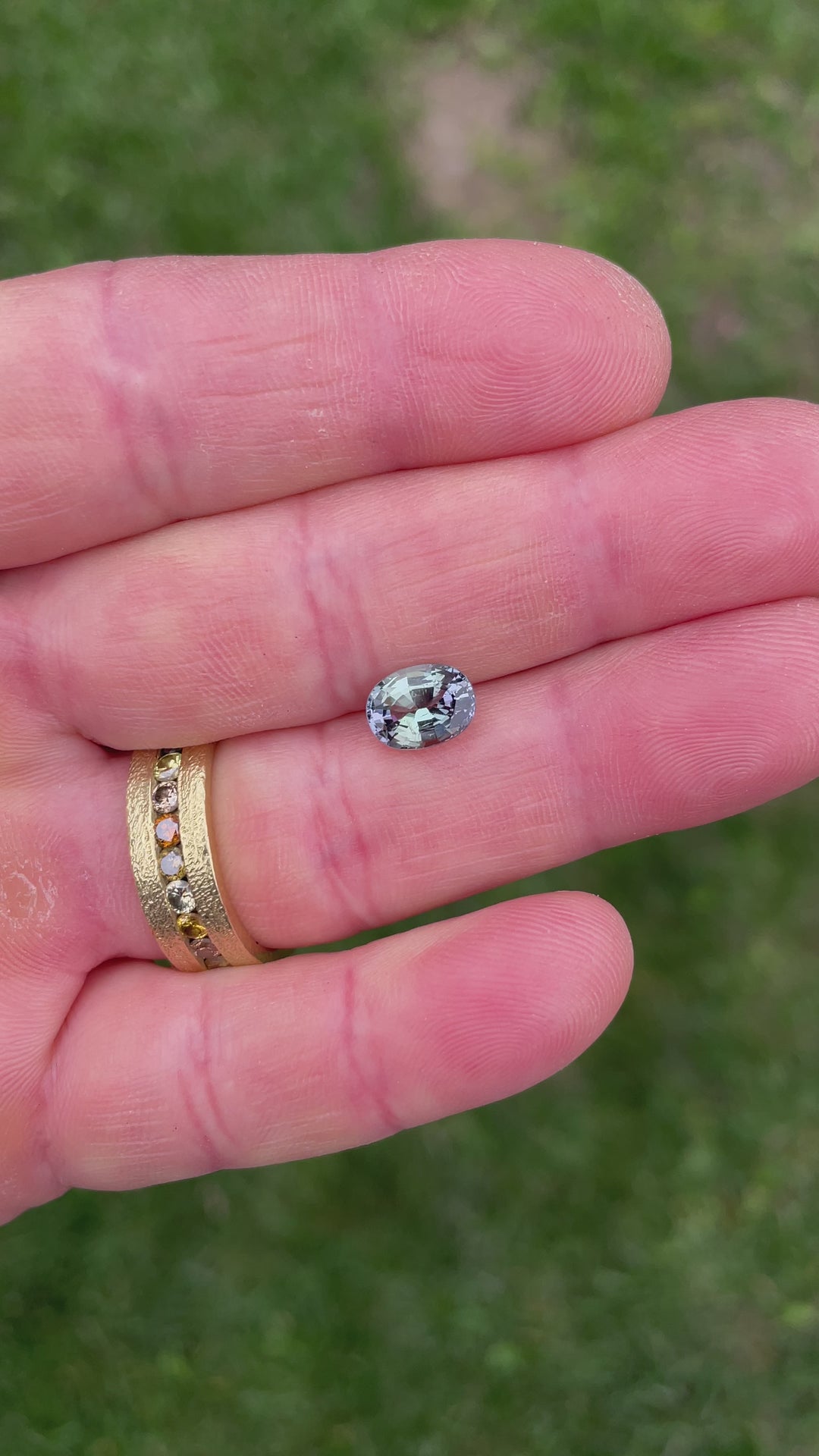 Rotating video of a 2.02 carat Tanzanite in hand, capturing its vibrant color shifts from teal to purple and green in natural light.
