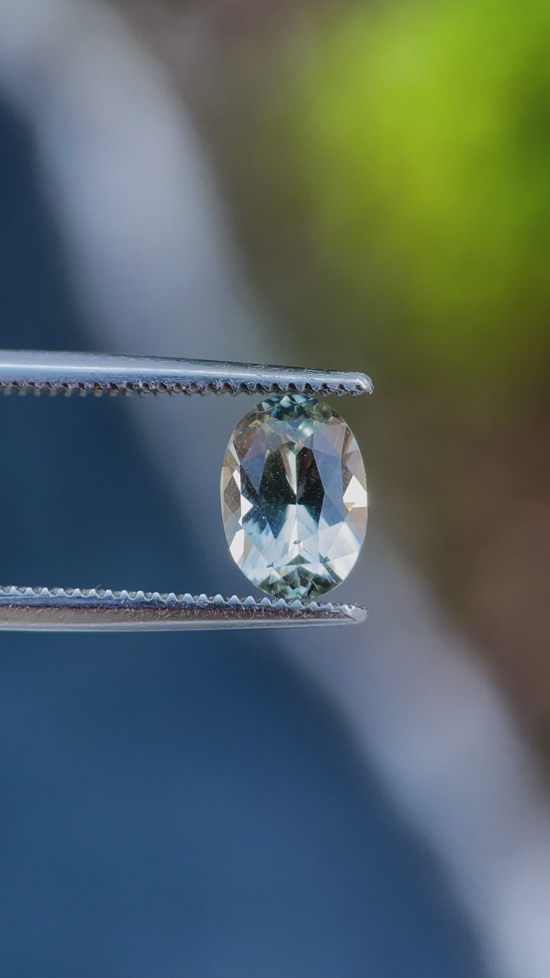 A detailed video showcasing a 2.05-carat oval-cut sapphire from Sri Lanka, displaying its natural gray and yellow hues under different lighting angles.