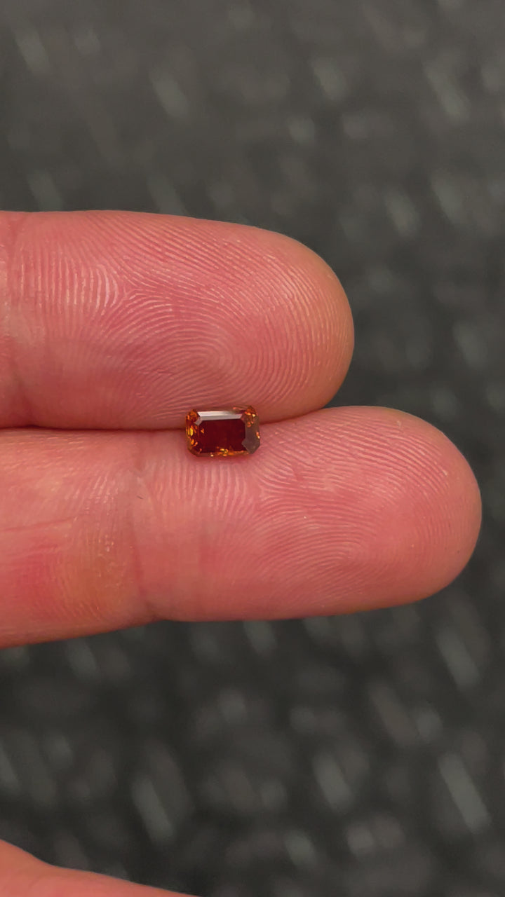 A 1.02-carat fancy deep brown orange (cognac) diamond, captured in motion to highlight its emerald step-cut brilliance. A rare and beautiful gemstone ethically sourced from South Africa.