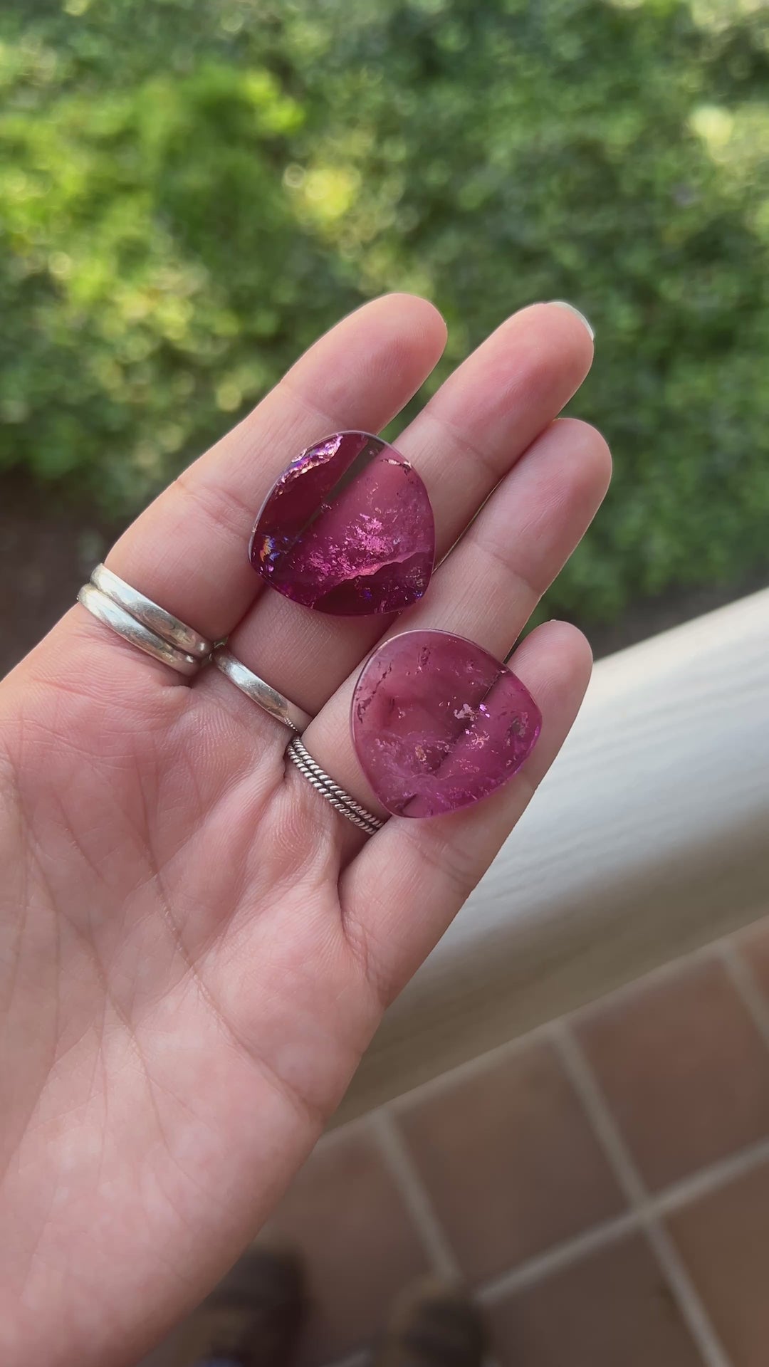 Explore a striking pair of natural deep pink tourmaline slices from Congo, totaling 65.78 carats. Each polished slice measures approximately 25.7 mm across, showcasing saturated raspberry and cranberry-pink coloration, translucent crystal, and distinctive natural inclusions.