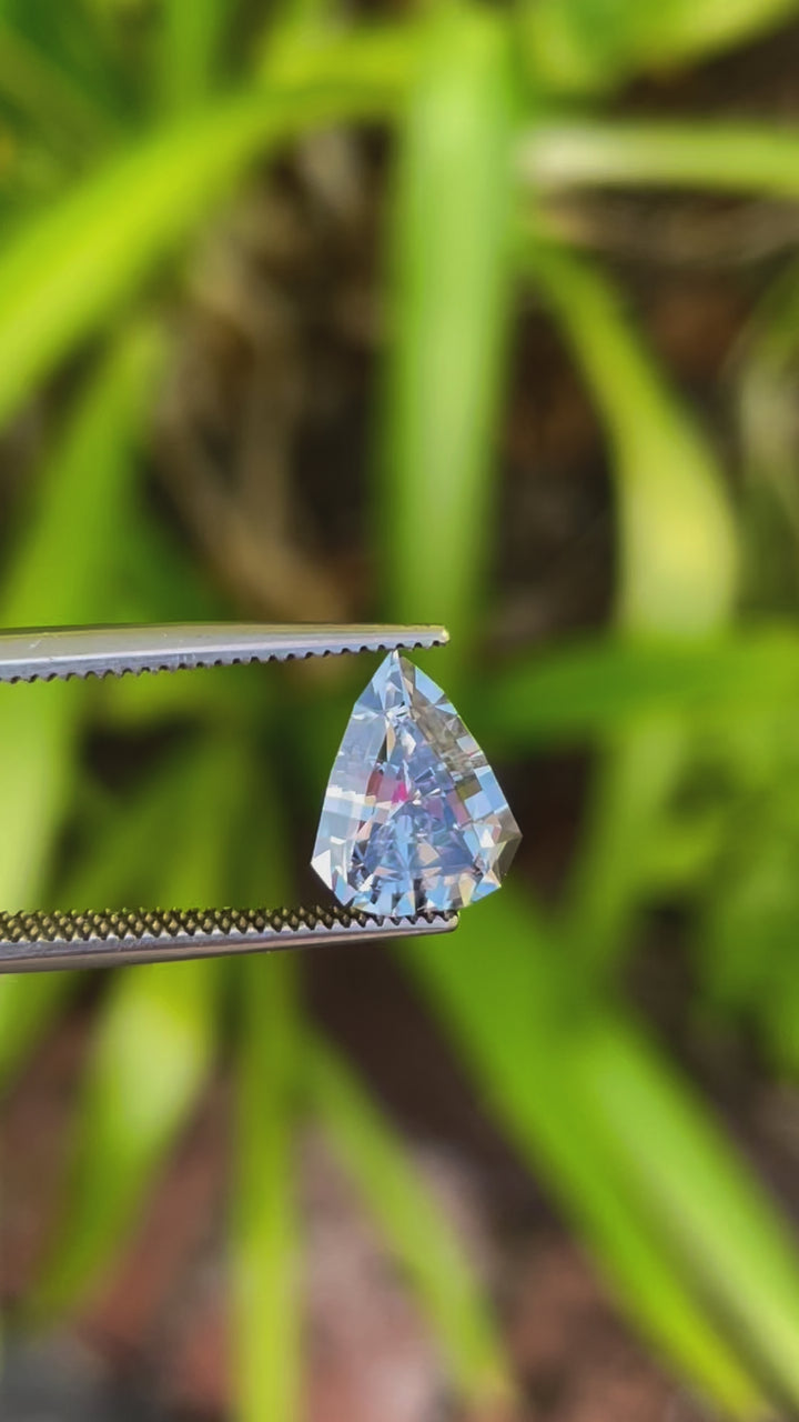 Close-Up Video of a Custom Modified Shield Cut Sapphire Gemstone with Color Shift from Pale Lavender to Pale Blue, Weighing 2.44 Carats, with Dimensions 10.33 x 8.17 x 4.76 mm, from Sri Lanka - No Heat Treatment