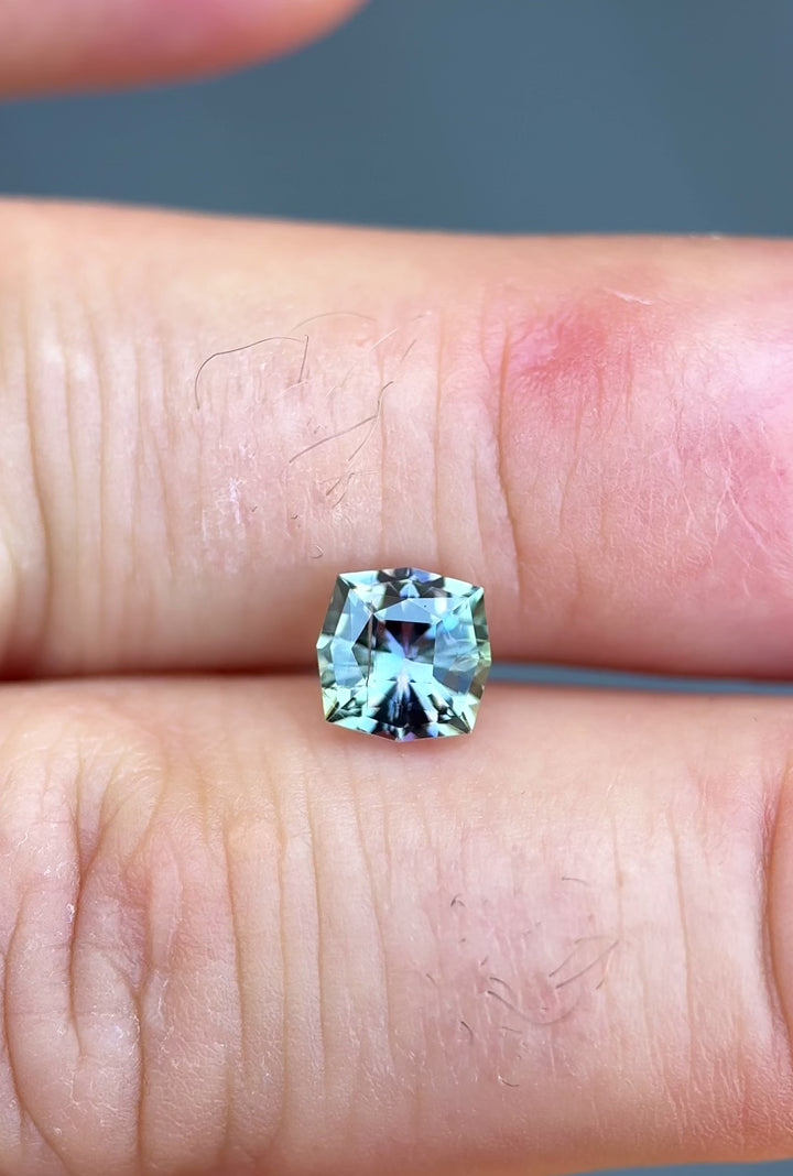 Close-up video of untreated Tanzanite in ultra-precision kite shape displaying vivid brilliance and color zoning in natural daylight