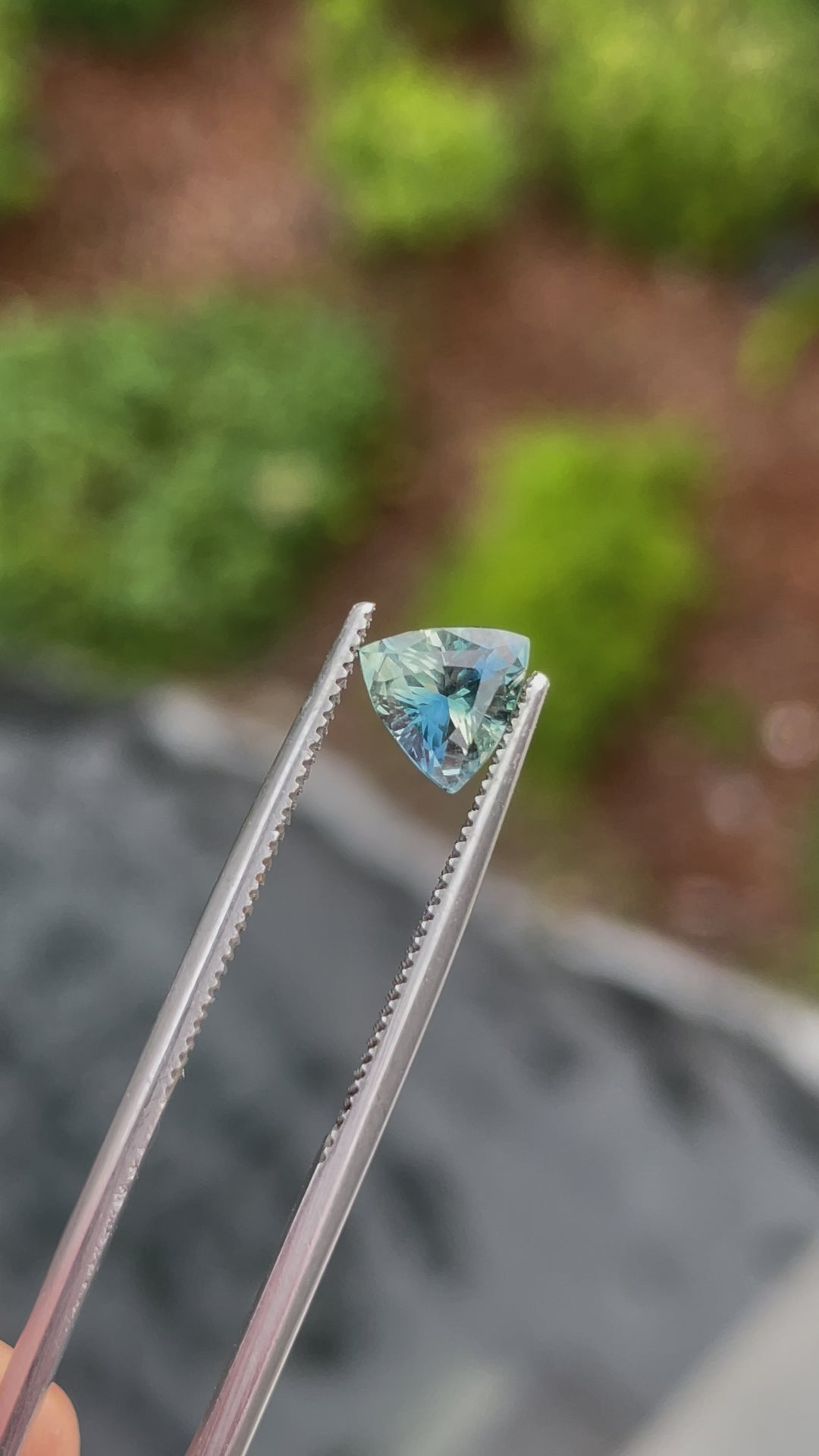 etailed video of a trillion brilliant mixed cut sapphire weighing 1.17 carats. Originating from Madagascar, this bi-color gem features blue-green and yellow tones, untreated to preserve its natural beauty, shown in rotating angles to highlight its brilliance.