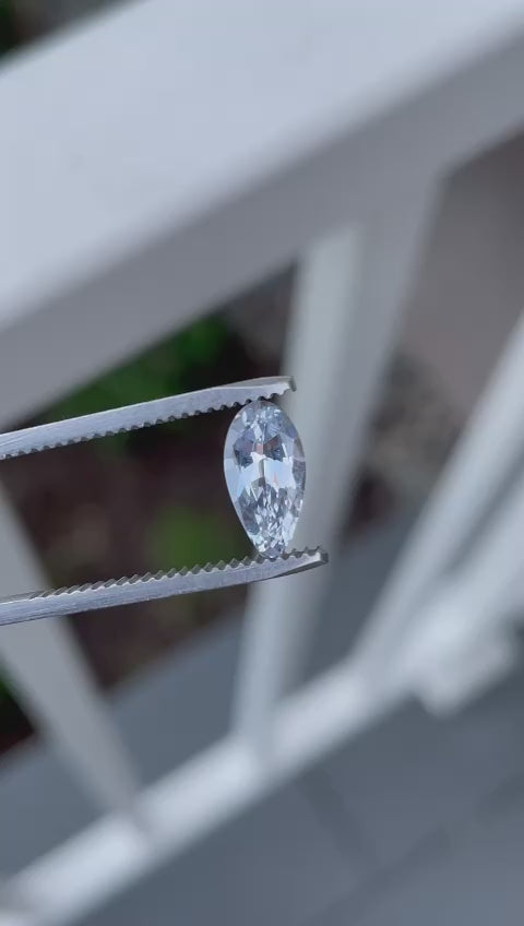 Interactive video display of a 1.42 carat light sage green sapphire in natural light, highlighting its origin from Sri Lanka and no heat treatment. The video demonstrates the gemstone’s custom pear shape and its reflective qualities.