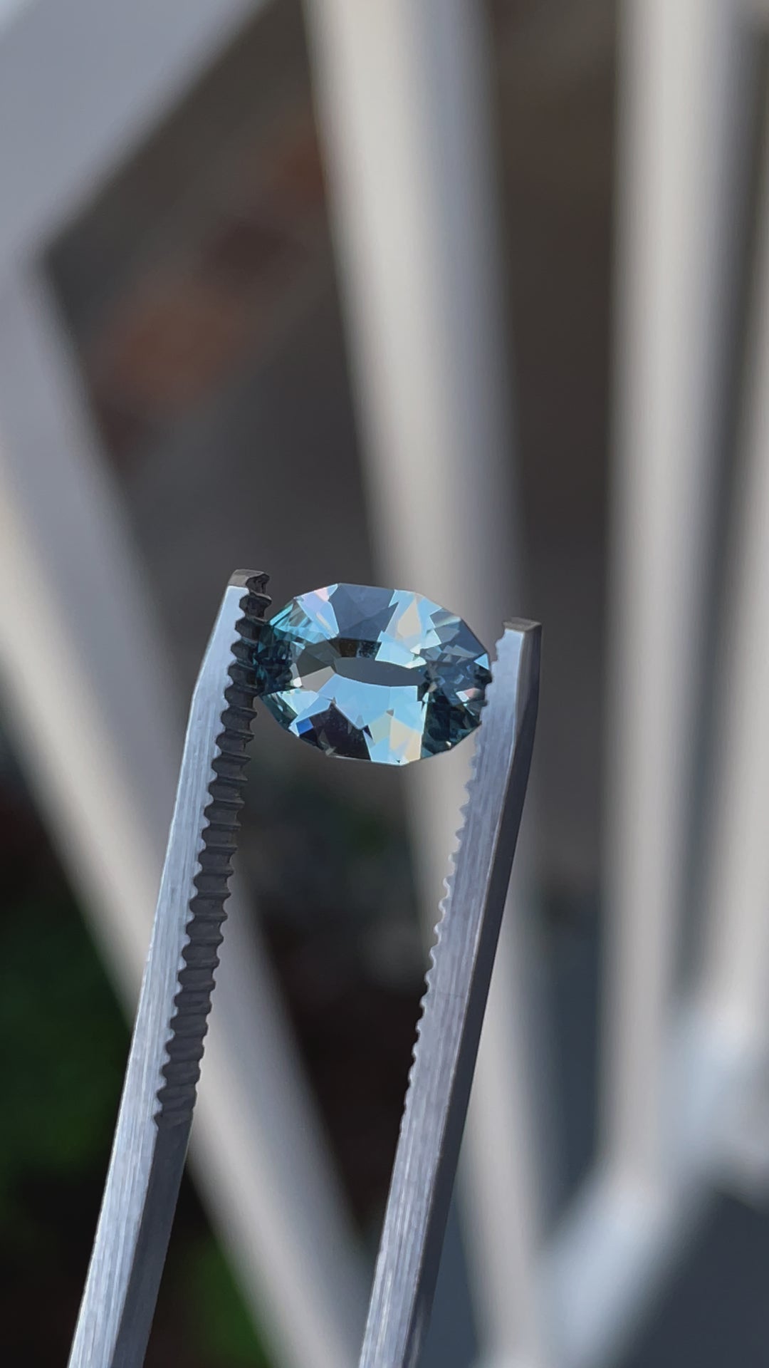 Up-close video of a 1.61-carat seafoam blue sapphire, oval mix brilliant cut, displaying its sparkling facets and seafoam blue hue.
