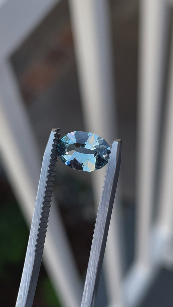 Up-close video of a 1.61-carat seafoam blue sapphire, oval mix brilliant cut, displaying its sparkling facets and seafoam blue hue.