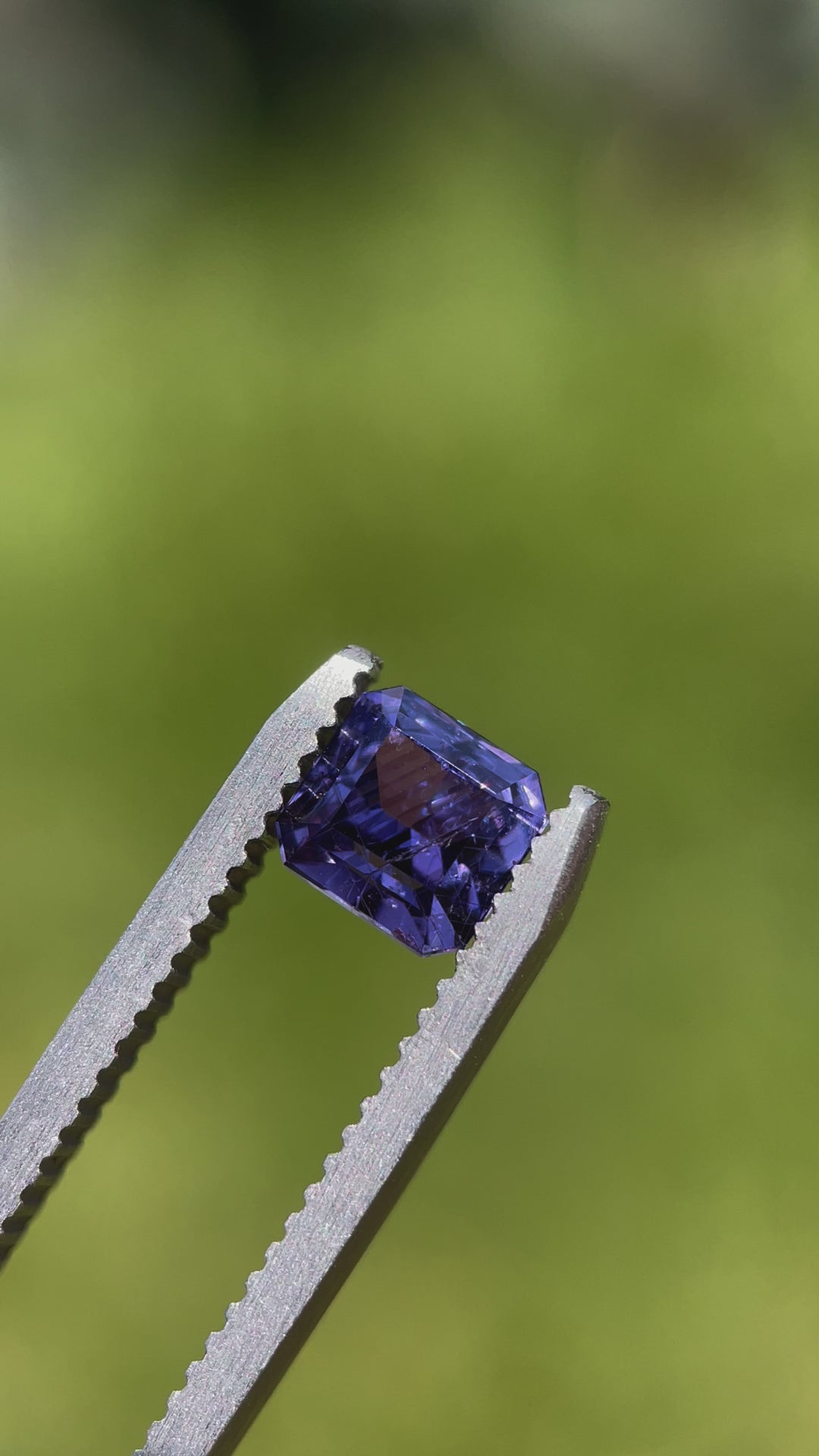 A close-up view of a 1.68 carat purple sapphire in a custom octagonal step cut, highlighting its natural vibrance and elegance. Origin: Umba River, Tanzania.