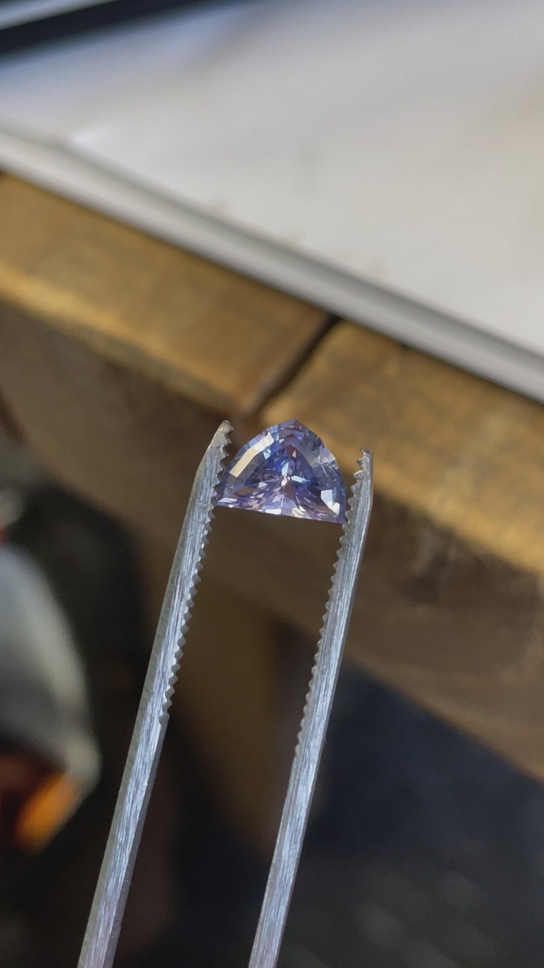 Macro video of an unheated arrow-cut sapphire from Sri Lanka,  showing its precise faceting and vibrant hues.