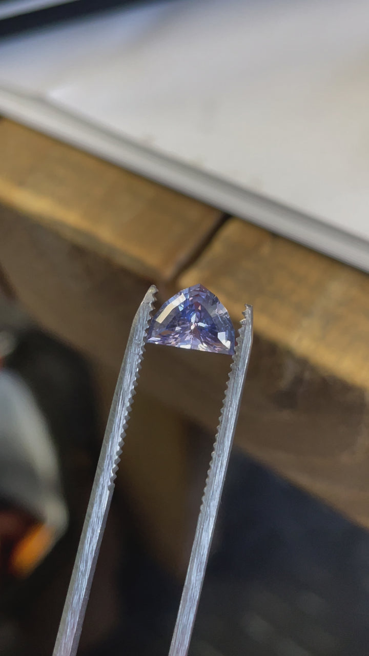 Macro video of an unheated arrow-cut sapphire from Sri Lanka,  showing its precise faceting and vibrant hues.