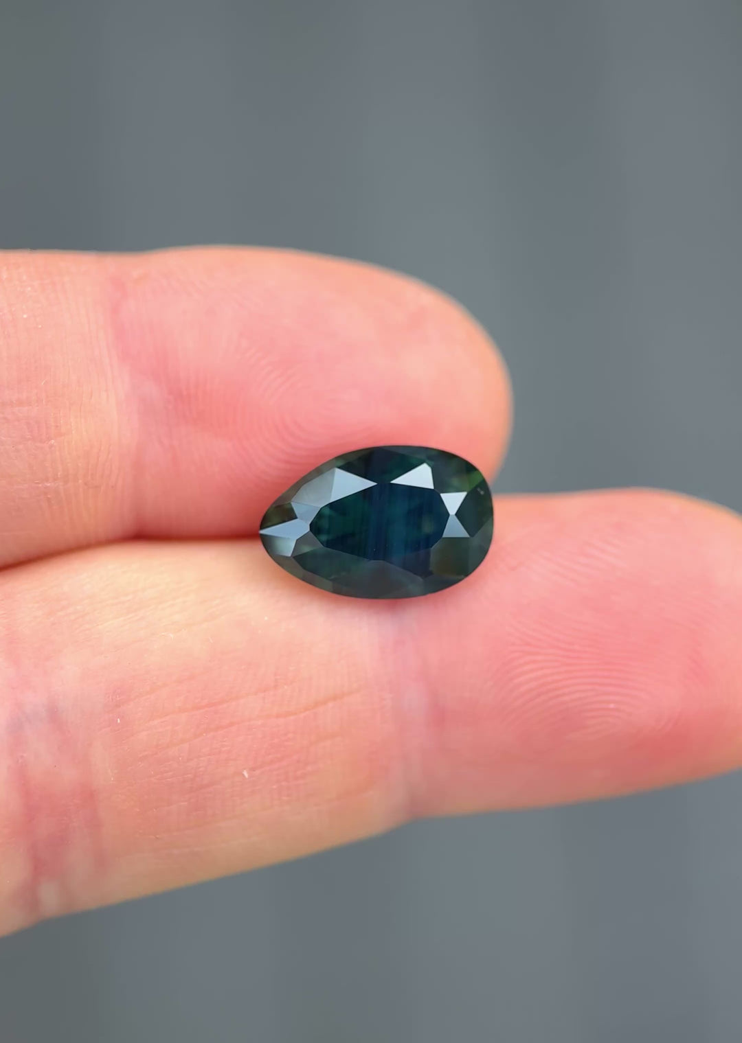 Large Nigerian sapphire in motion highlighting depth of color and custom poval brilliant faceting.