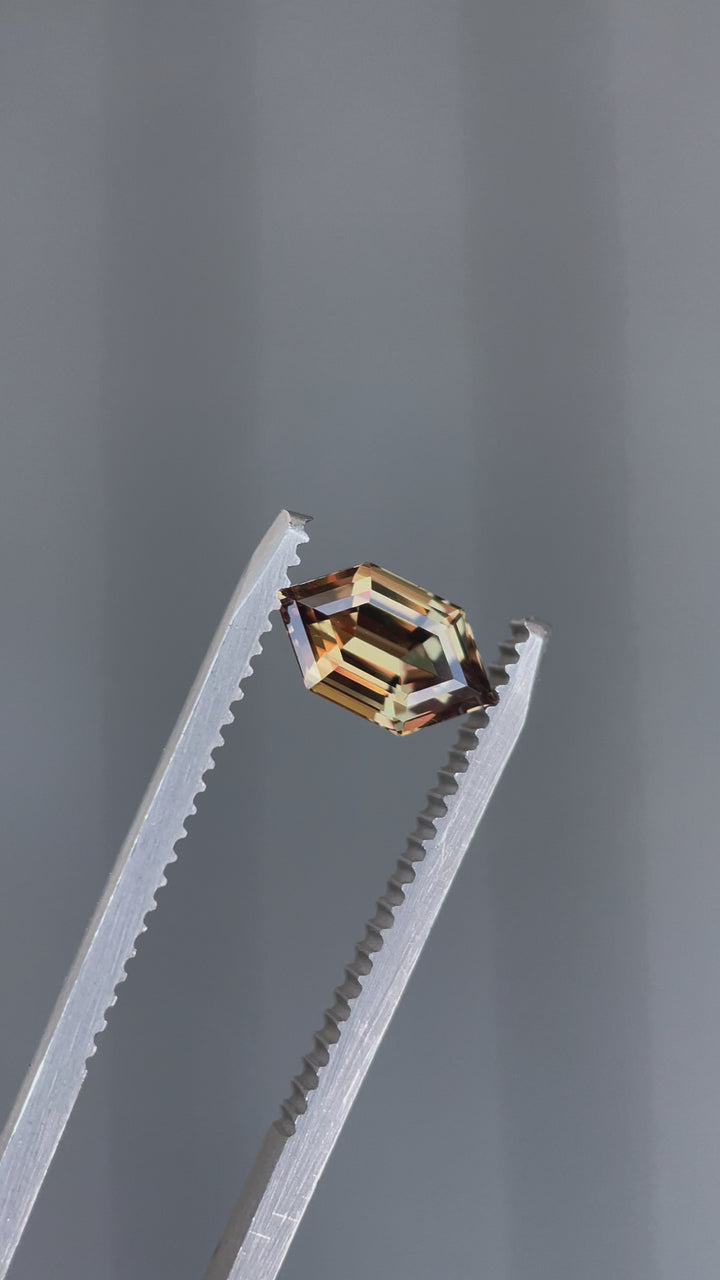 A close-up video of a rare 1.22-carat sapphire from Songea, Tanzania, highlighting its precision-cut hexagonal shape and dynamic color shifts from different angles.
