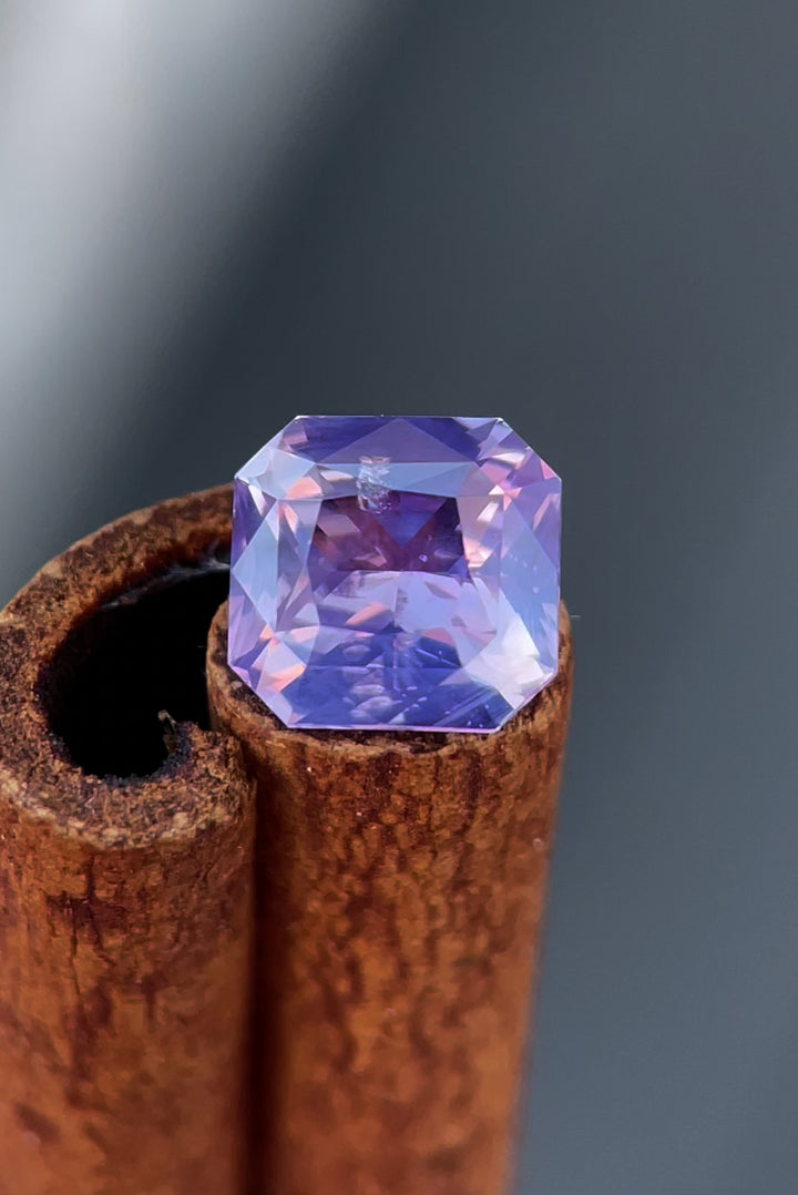 Experience the mesmerizing beauty of a 1.57-carat opalescent sapphire featuring a custom radiant cut. This Sri Lankan gemstone shines with pink and purple hues, ethically sourced with no treatments. Perfect for unique jewelry designs.