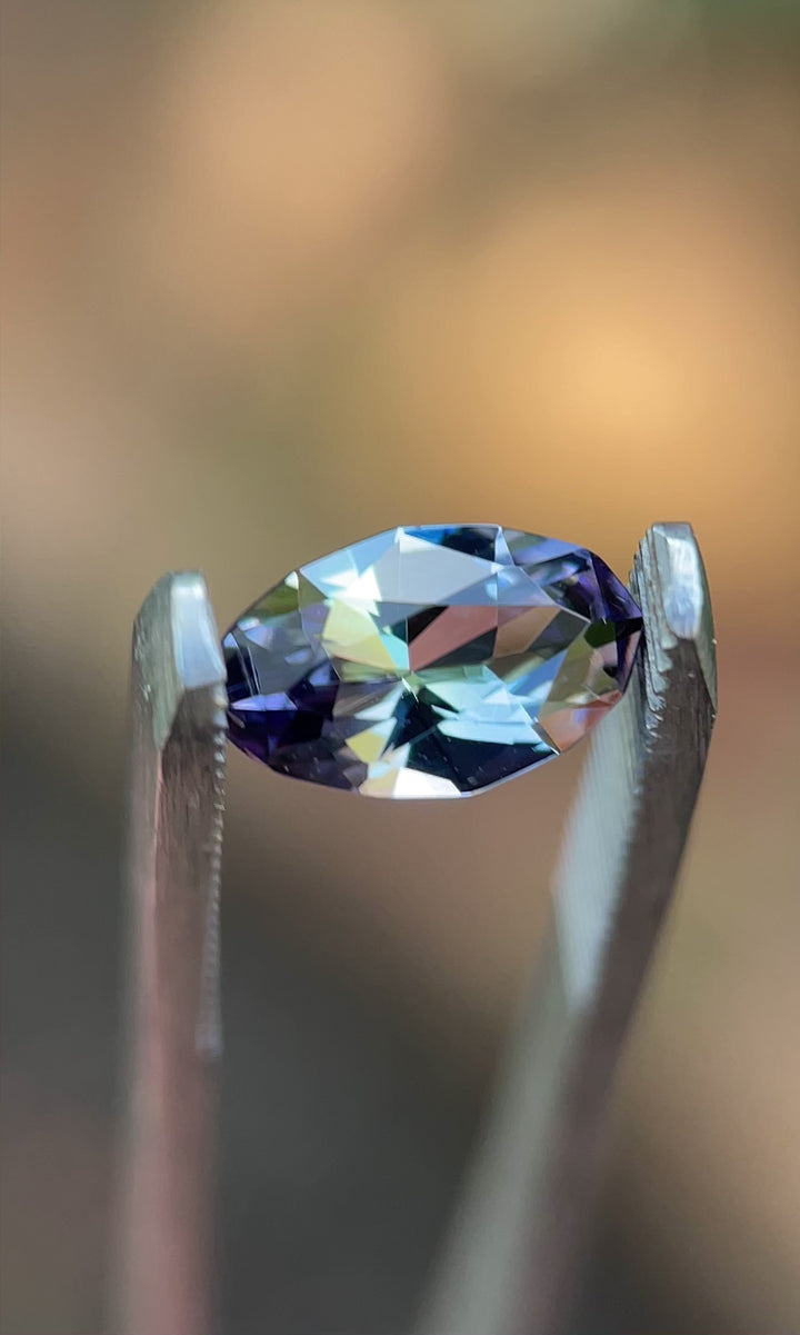 Rotating video of 1.58-carat Tanzanite showing teal, gray, and purple hues with brilliant sparkle in natural light.