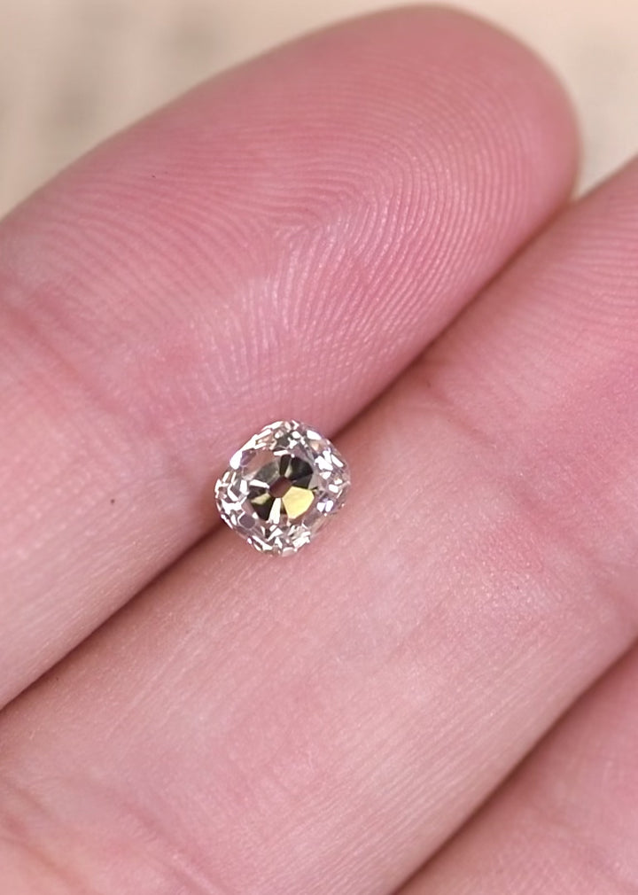 Old mine cut diamond under UV light showing strong fluorescence and glowing effect.