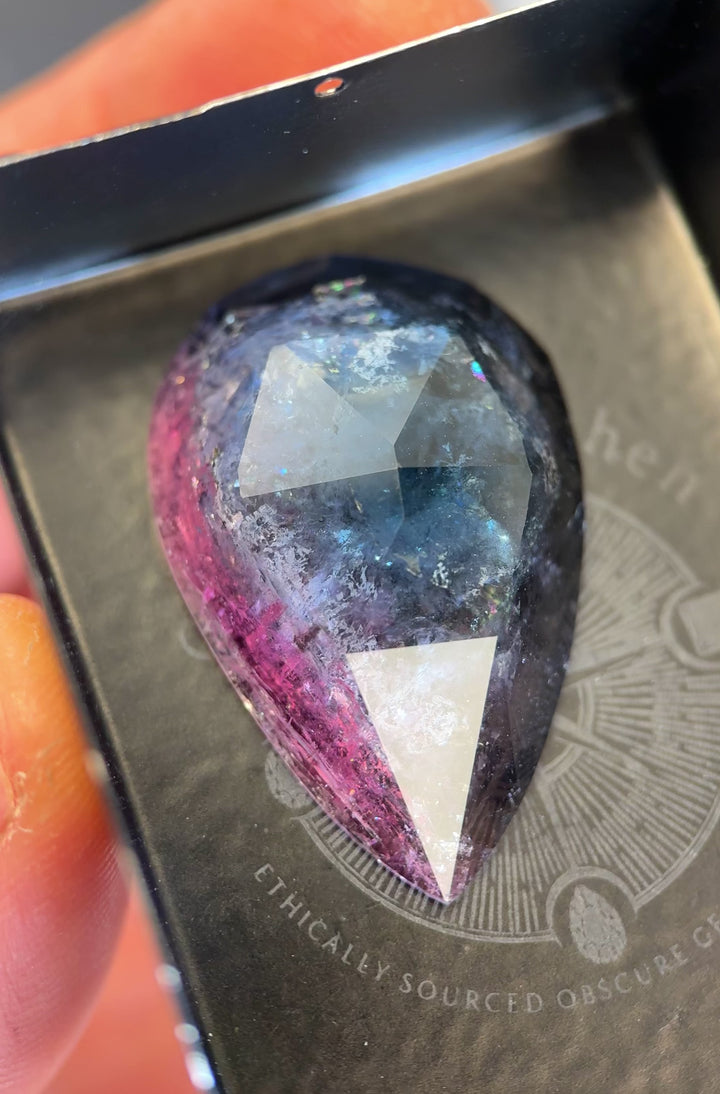 Close-up video of large 46.80 carat tourmaline highlighting surface texture, rose cut faceting, and the interplay of pink, purple, and blue tones from Paprok Mine, Afghanistan