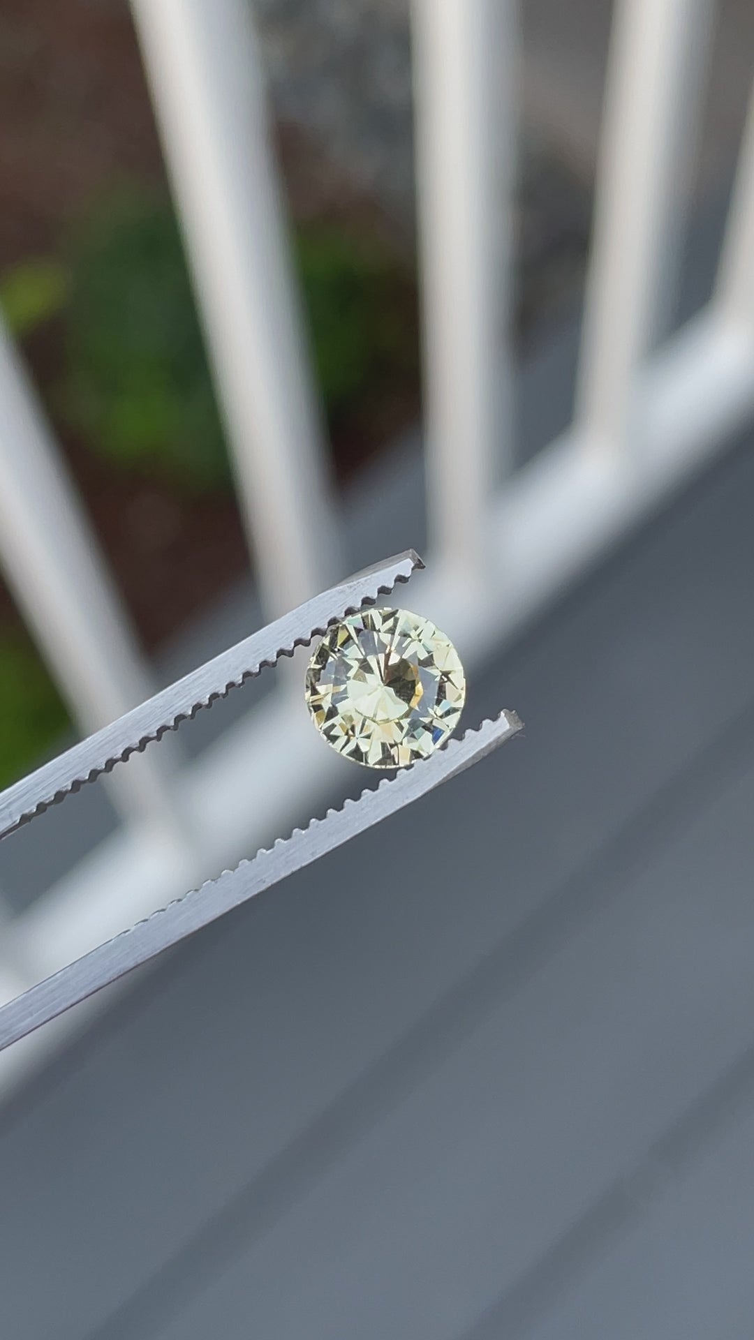 360-degree close-up video of a 1.59-carat round brilliant peach yellow sapphire from Sri Lanka, revealing its fiery sparkle and precision cut.