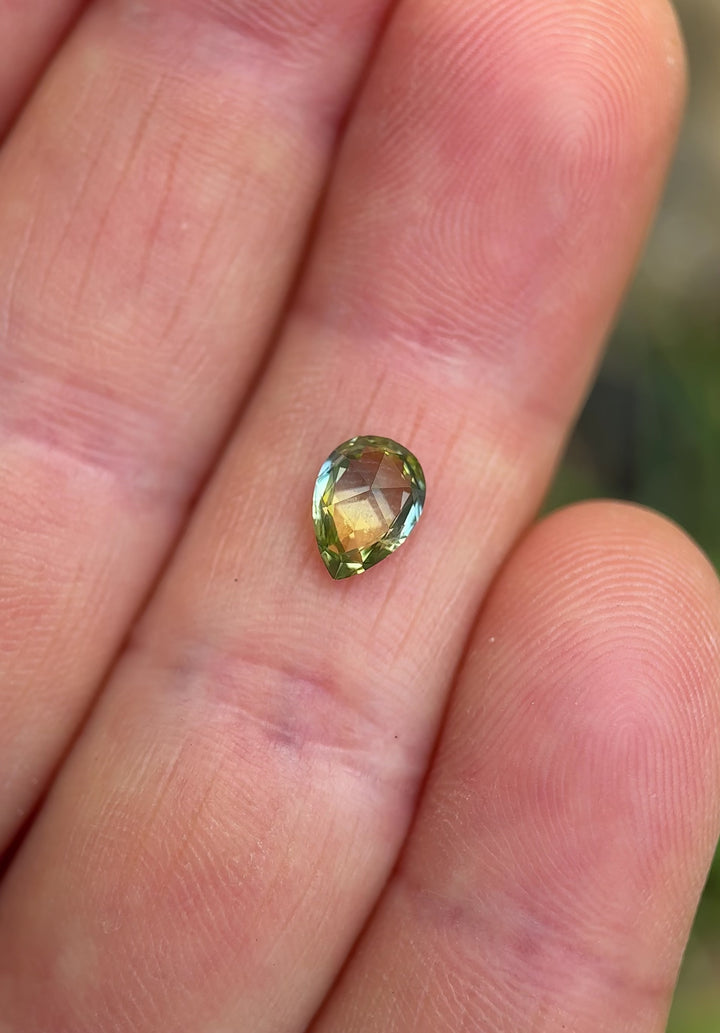 High-definition video of a Madagascar parti sapphire highlighting its brilliance and mix of teal, yellow, and blue hues.