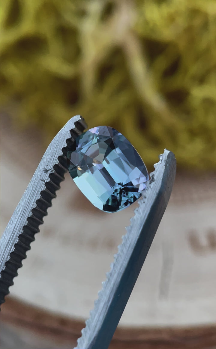 Rotating view of a 1.36-carat Tanzanite, revealing its stunning color shift from teal to violet. The modified cushion cut enhances the gem’s depth and fire, making it a perfect choice for fine jewelry.