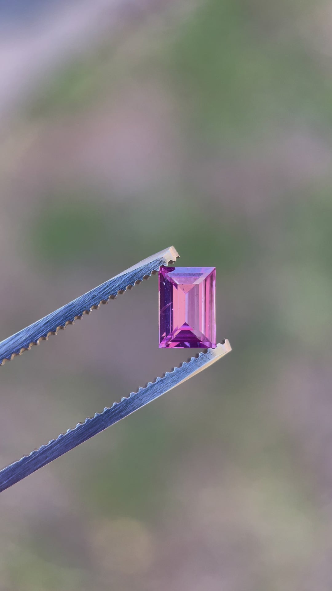 Engaging video showcasing a 1.10 carat sapphire with an emerald cut, capturing the gem's dynamic play of pink, purple, and mulberry colors, sourced from Sri Lanka.