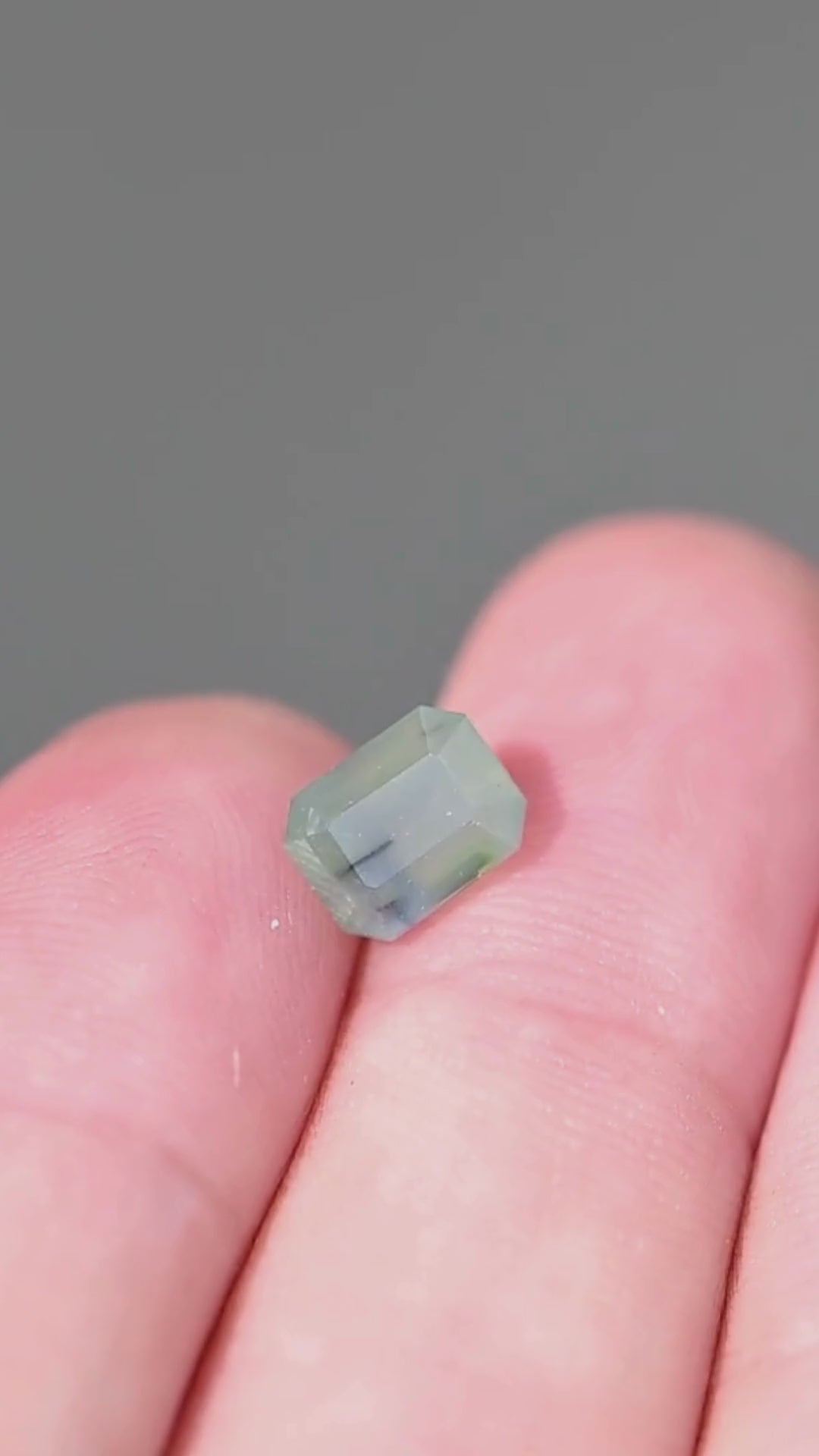 Explore the scale and softly layered seafoam, teal and blue color of this untreated 1.88ct emerald cut sapphire from Gombe, Nigeria. Its opalescent appearance and visible natural inclusions give the gemstone a distinctive character.