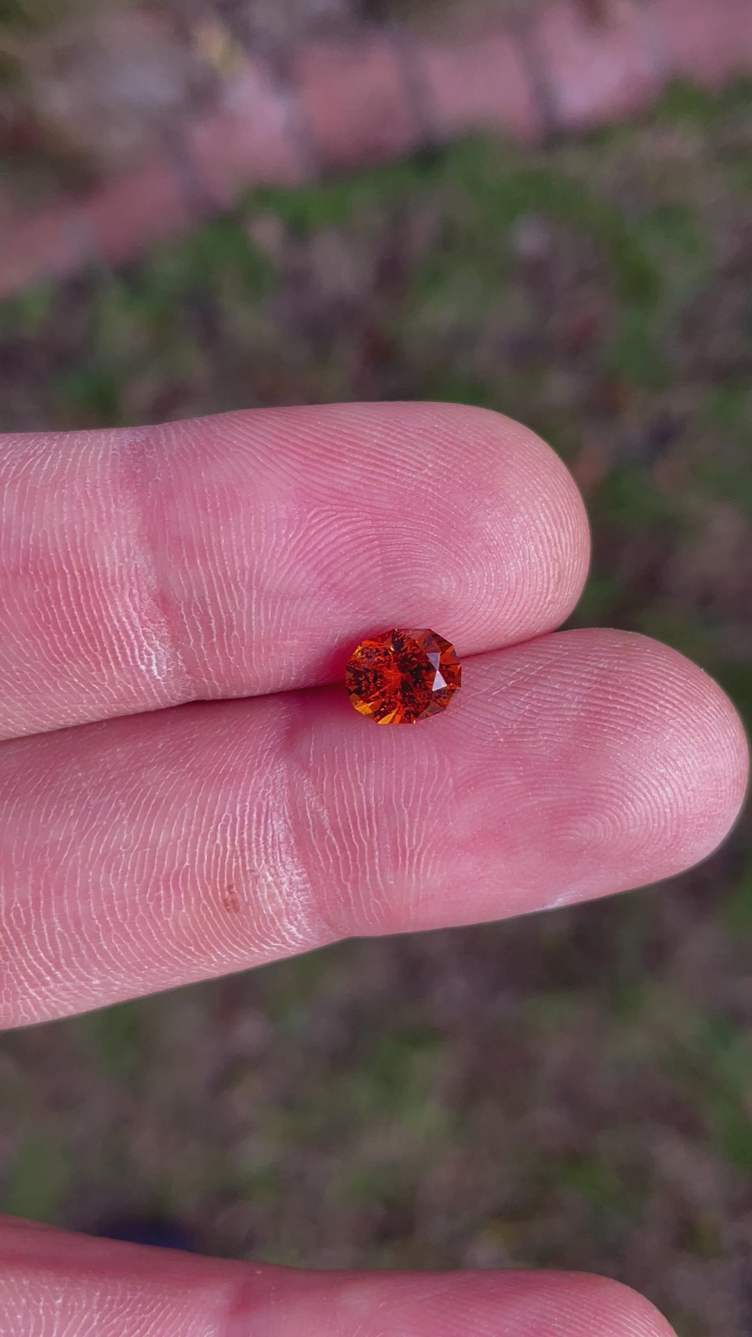 360-degree rotating view of a 1.61-carat Hessonite Garnet with custom oval cut, showcasing its orange-brown brilliance.