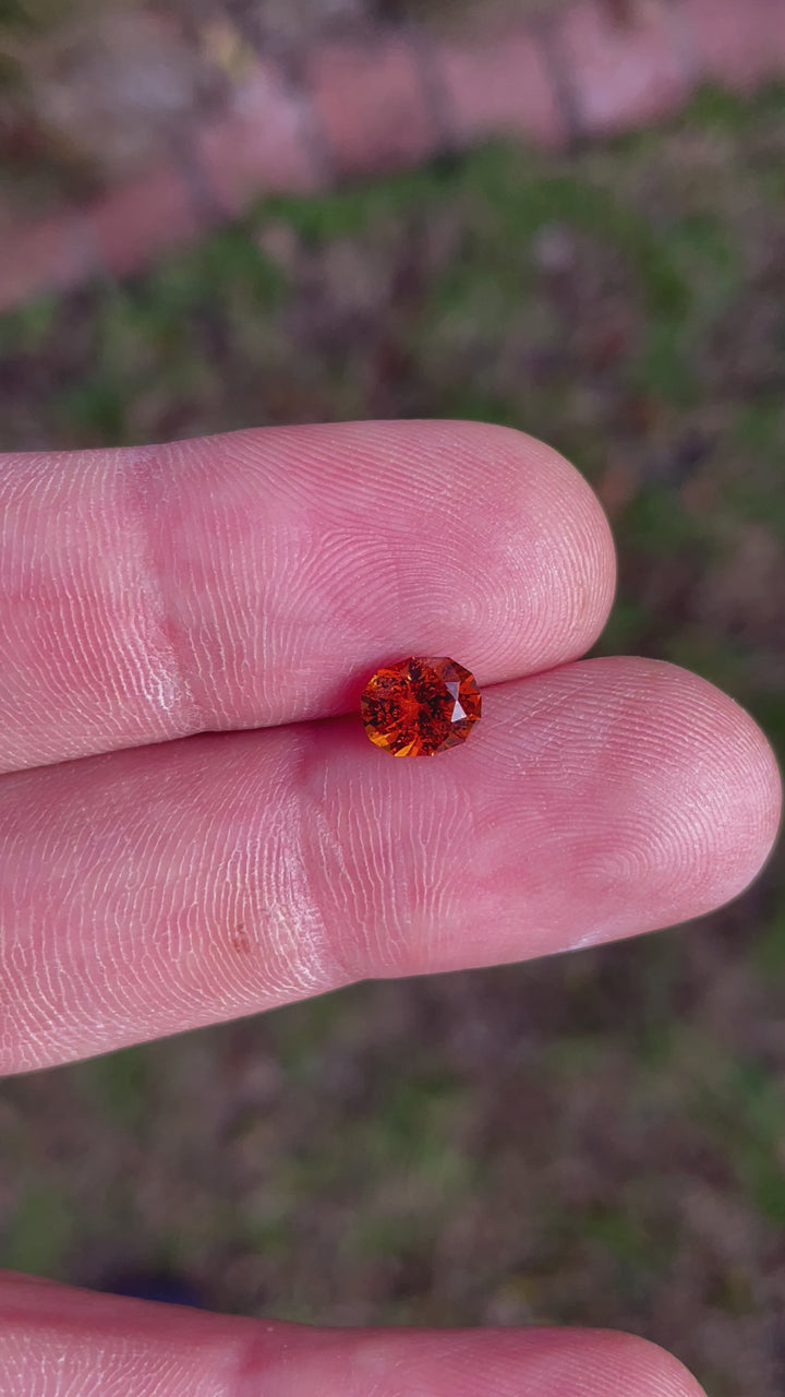 360-degree rotating view of a 1.61-carat Hessonite Garnet with custom oval cut, showcasing its orange-brown brilliance.