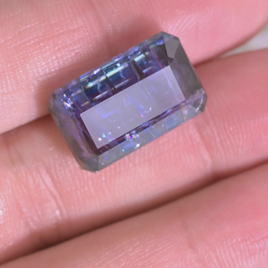 Close-up video of a large 18.04 carat Tanzanite from Tanzania, slowly turned to reveal depth, clarity, and color zoning in a precision octagonal step cut.