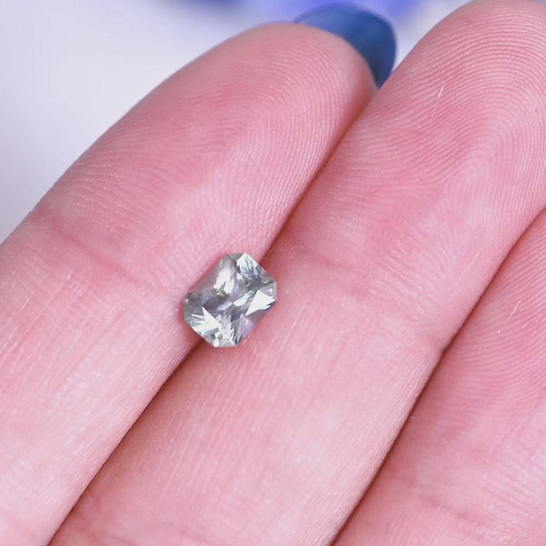 0.96ct teal gray blue Montana sapphire mixed radiant cut rotating under natural light, showing sparkle, facet brilliance, and untreated clarity from El Dorado Bar Deposit.