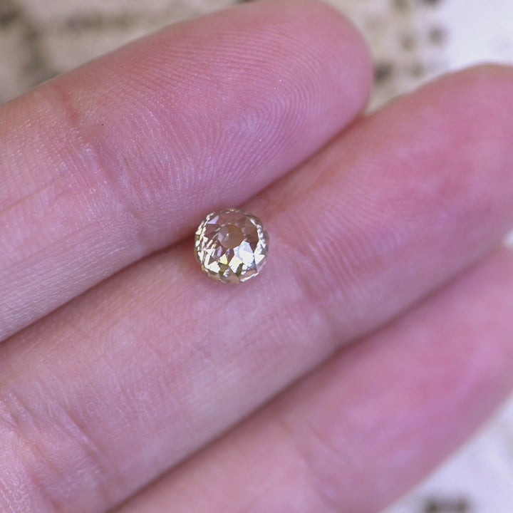 Rotating loose fancy light brown champagne Mughal cut diamond from South Africa, revealing its geometric faceting and warm brilliance in changing light.