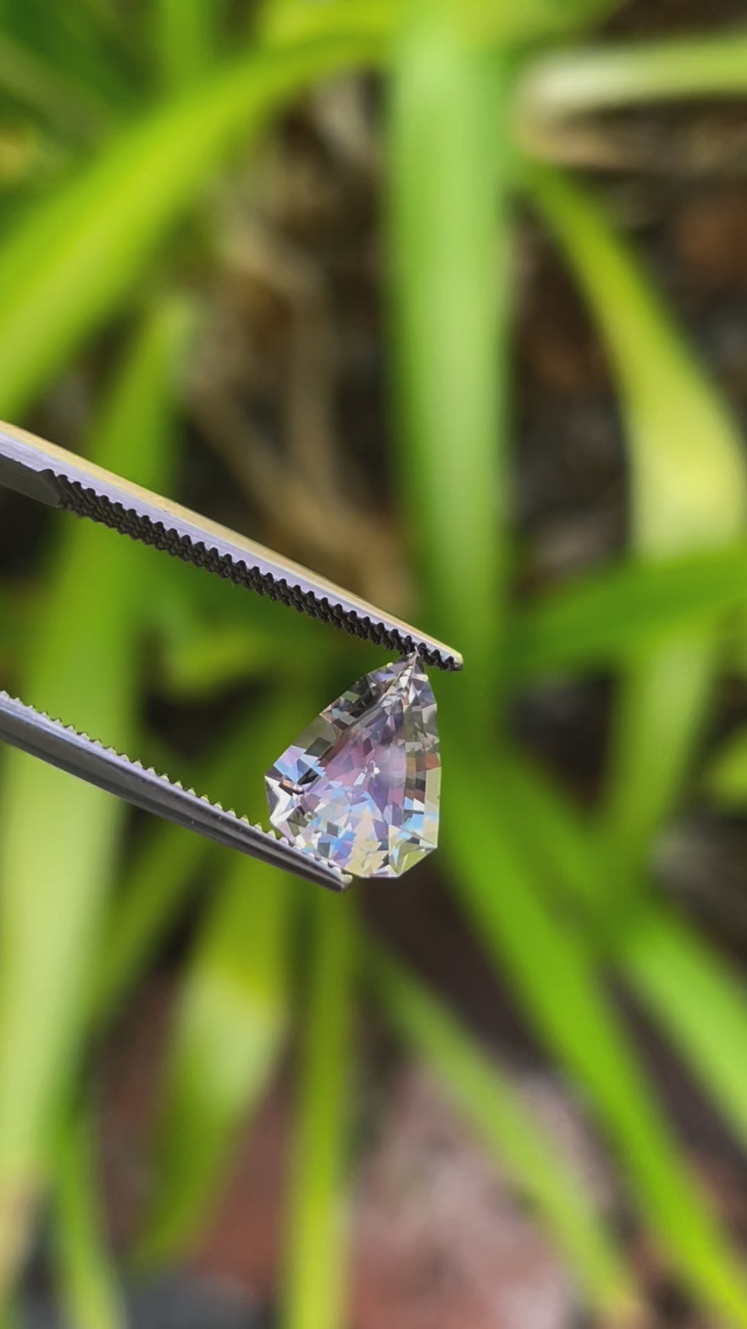 High-Resolution Video of a Custom Modified Shield Cut Sapphire Gemstone Displaying Color Shift from Pale Lavender to Pale Blue, Weighing 2.44 Carats, with Dimensions 10.33 x 8.17 x 4.76 mm, from Sri Lanka - No Heat Treatment