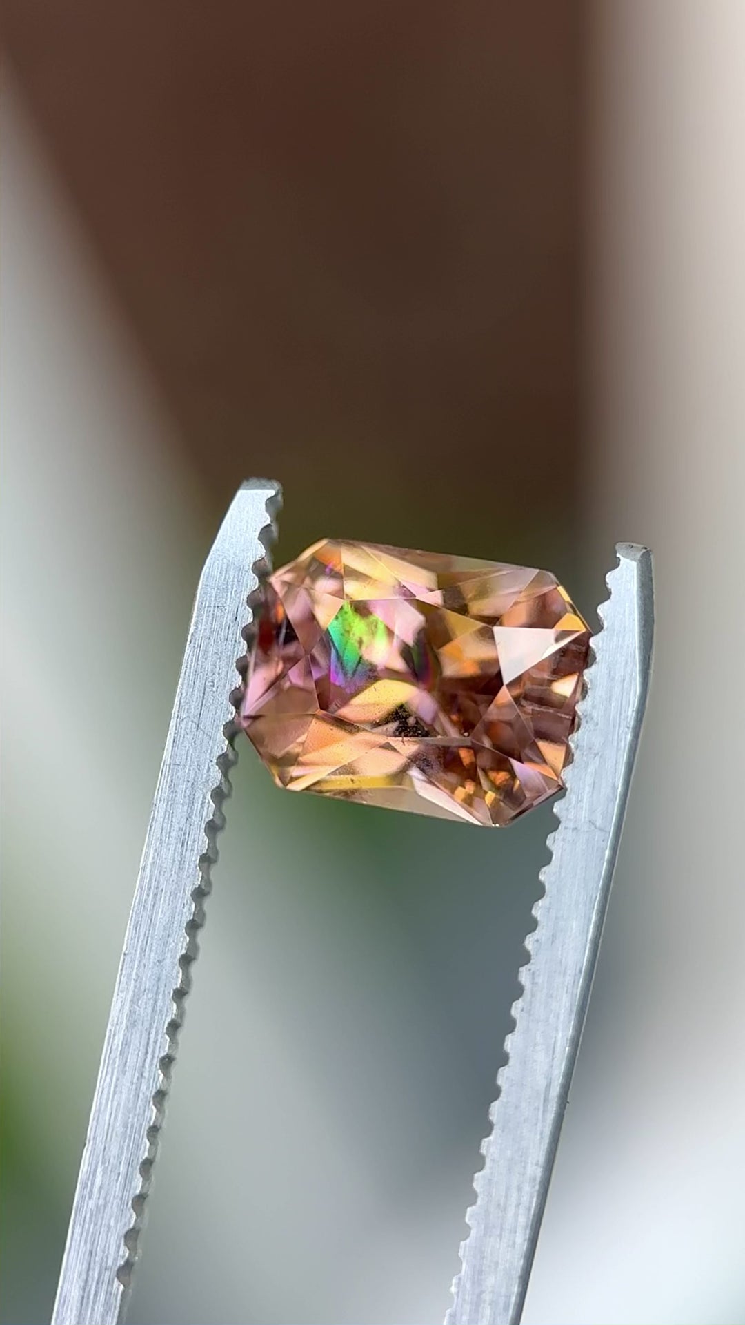 Macro video of a 2.51ct Tanzanite from Merelani Hills, highlighting its radiant cut and dynamic multicolor sparkle from champagne to orange and lavender.