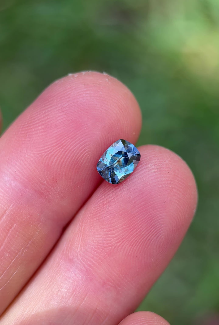 Macro video of the Umba River sapphire, 1.23 carats, showing shifting teal and purple hues and intricate faceting in antique cushion cut.