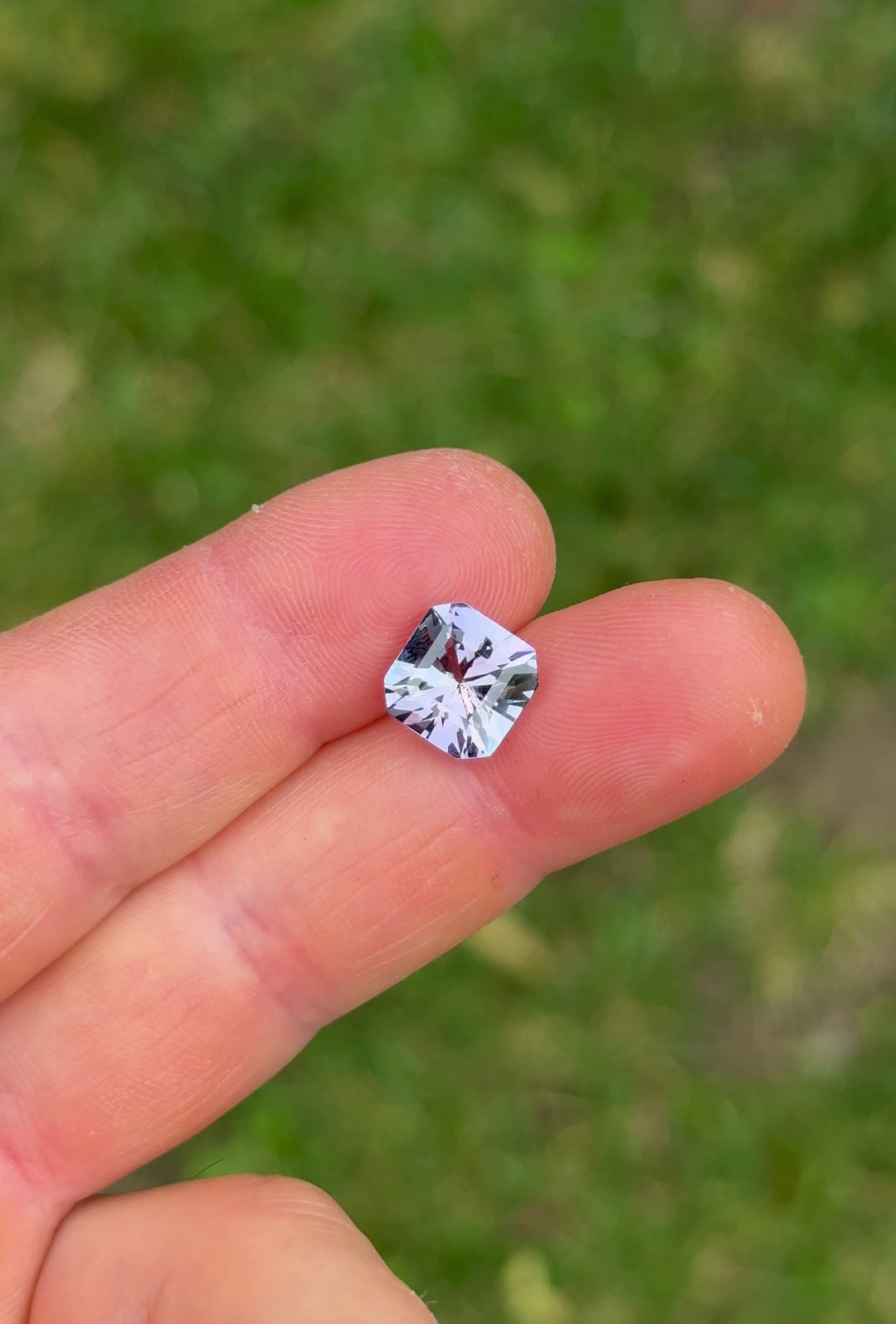 Video showcasing 4.59ct Tanzanite in a squared octagon brilliant cut with color transitions under natural lighting