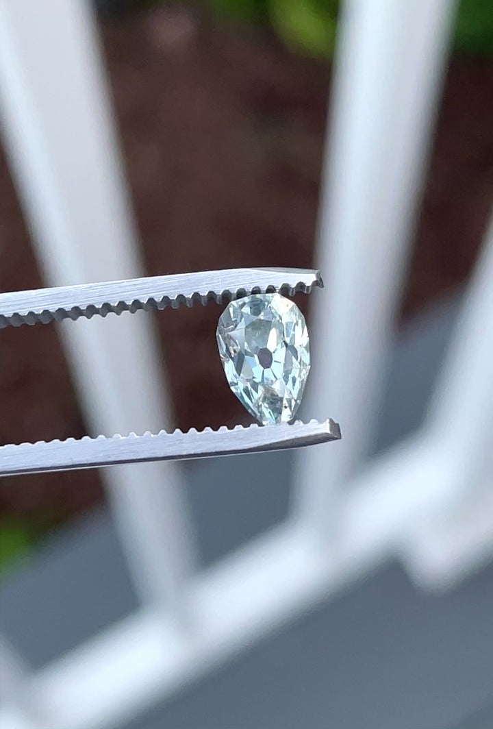 Rotating video of a 1.41-carat unheated sapphire in a pear-oval (poval) cut, revealing shifting tones of yellow, green, and blue as light moves across the gem. Sourced from Chimwadzulu Hill, Malawi.