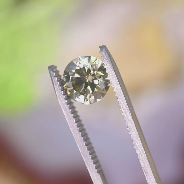 Loose diamond displaying very strong green fluorescence highlighting rare visual effect under lighting conditions.