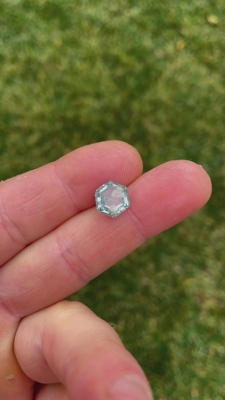Close-up video of a Montana-origin sapphire in teal green, featuring its hexagonal shape and 4.00 carat weight.