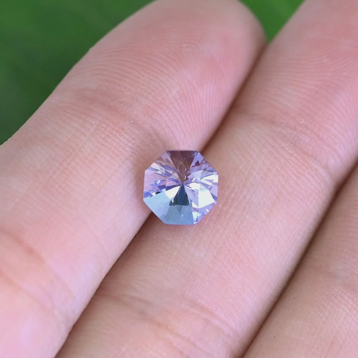 2.38 carat periwinkle violet Tanzanite octagon rotating under natural light, custom mix brilliant faceting from Merelani Hills Tanzania showing color shift and sparkle for custom jewelry design